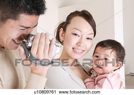 Father filming family with video camera View Large Photo Image Stock Image - Father filming family with video camera. Fotosearch