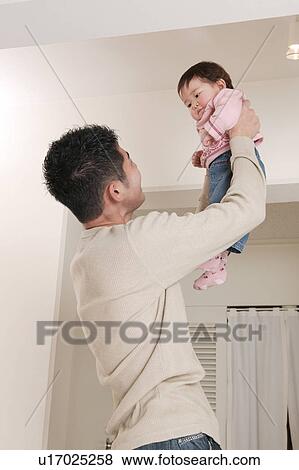 Father picking up baby View Large Photo Image Stock Photo - Father picking up baby. Fotosearch