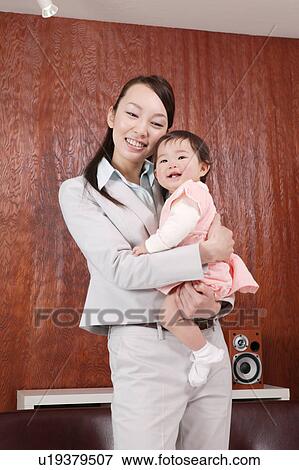 Mother carrying baby View Large Photo Image Stock Photo - Mother carrying baby. Fotosearch