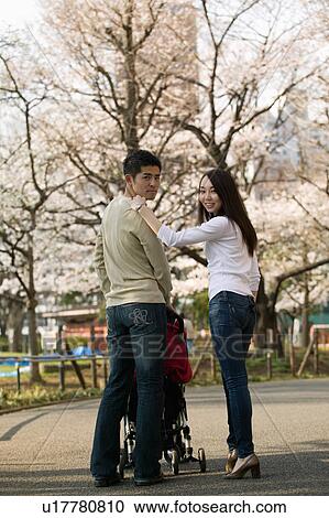 Parents pushing baby stroller View Large Photo Image Stock Image - Parents pushing baby stroller. Fotosearch