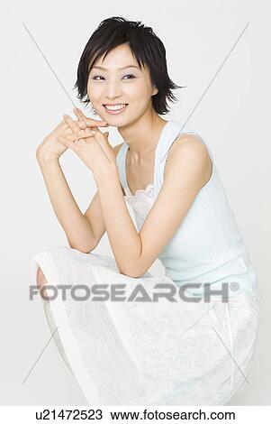 Young woman crouching View Large Photo Image Stock Image - Young woman crouching. Fotosearch