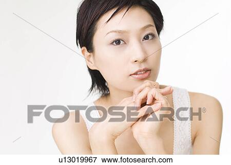Young woman looking at camera View Large Photo Image Stock Photo - Young woman looking at camera. Fotosearch