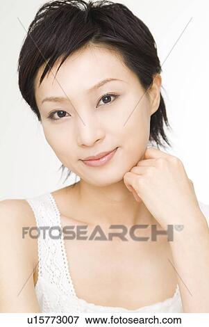 Young woman looking at camera View Large Photo Image Stock Photo - Young woman looking at camera. Fotosearch