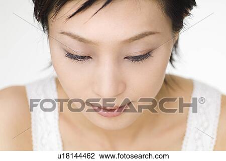 Young woman looking down View Large Photo Image Stock Image - Young woman looking down. Fotosearch
