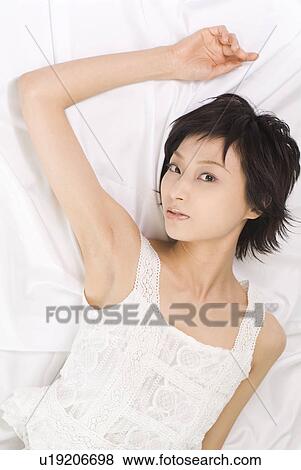 Young woman lying down View Large Photo Image Stock Photo - Young woman lying down. Fotosearch