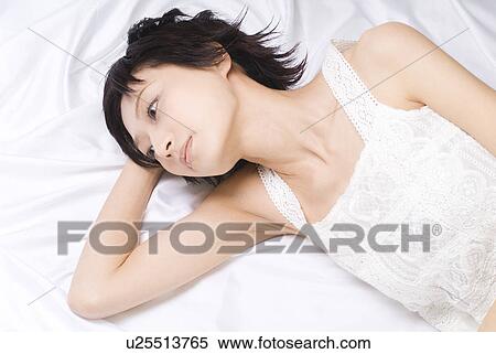 Young woman lying down View Large Photo Image Stock Photography - Young woman lying down. Fotosearch