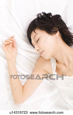 Young woman sleeping View Large Photo Image Stock Image - Young woman sleeping. Fotosearch