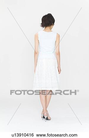 Young woman standing, rear view View Large Photo Image Stock Photograph - Young woman standing, rear view. Fotosearch