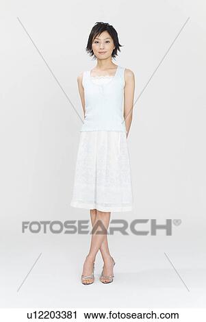 Stock Image - Young woman standing. Fotosearch