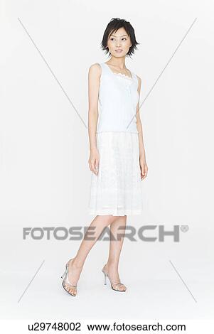 Stock Image - Young woman standing. Fotosearch