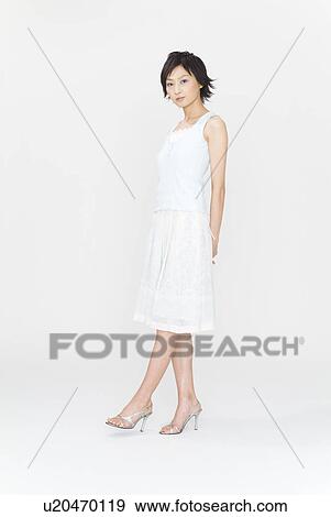 Young woman standing View Large Photo Image Stock Photo - Young woman standing. Fotosearch