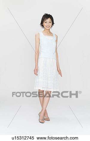 Stock Photography - Young woman standing. Fotosearch