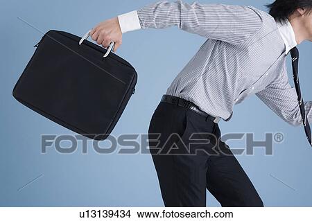 Businessman holding bag View Large Photo Image Picture - Businessman holding bag. Fotosearch