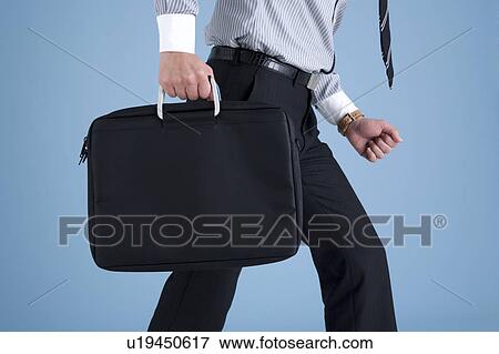 Stock Photo - Businessman holding bag. Fotosearch
