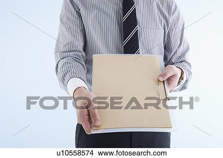 Picture - Businessman holding clipboard. Fotosearch