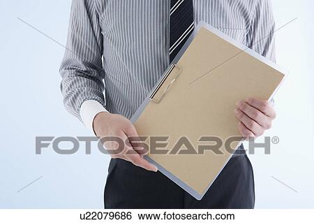 Stock Photograph - Businessman holding clipboard. Fotosearch