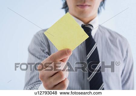 Businessman holding memo View Large Photo Image Stock Photo - Businessman holding memo. Fotosearch