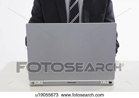 Stock Image - Businessman using computer. Fotosearch