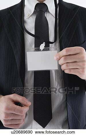 Stock Image - Businessman wearing ID card. Fotosearch