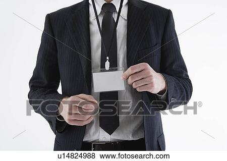 Businessman wearing ID card View Large Photo Image Stock Photo - Businessman wearing ID card. Fotosearch
