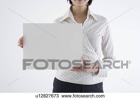 Businesswoman holding blank placard View Large Photo Image Stock Image - Businesswoman holding blank placard. Fotosearch