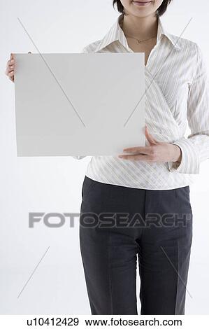 Businesswoman holding blank placard View Large Photo Image Stock Photo - Businesswoman holding blank placard. Fotosearch