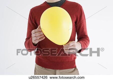 Man holding yellow balloon View Large Photo Image Stock Photograph - Man holding yellow balloon. Fotosearch