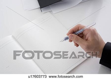 Notebook and hand holding pen View Large Photo Image Stock Image - Notebook and hand holding pen. Fotosearch