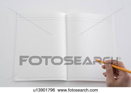 Stock Photograph - Notebook and hand holding pencil. Fotosearch