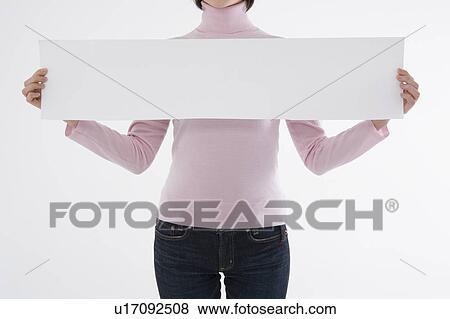 Woman holding blank paper View Large Photo Image Stock Photo - Woman holding blank paper. Fotosearch