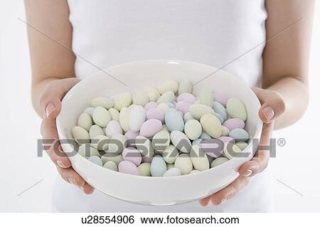 Woman holding bowl of candies View Large Photo Image Stock Photograph - Woman holding bowl of candies. Fotosearch