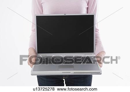 Woman holding laptop View Large Photo Image Stock Photo - Woman holding laptop. Fotosearch