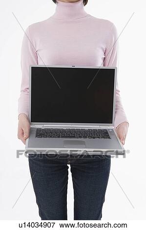 Woman holding laptop View Large Photo Image Stock Photo - Woman holding laptop. Fotosearch