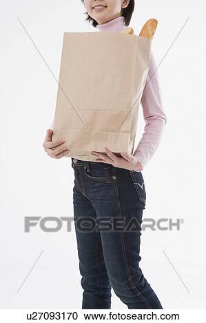 Woman holding paper bag View Large Photo Image Stock Image - Woman holding paper bag. Fotosearch