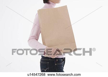 Stock Photo - Woman holding paper bag. Fotosearch