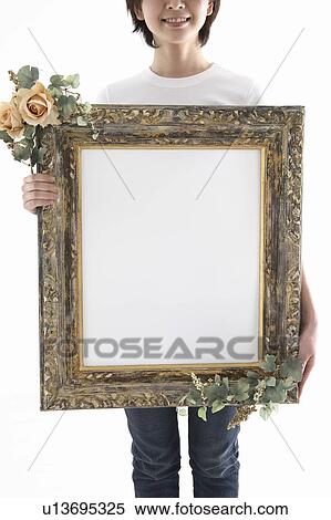 Woman holding picture frame View Large Photo Image Stock Photography - Woman holding picture frame. Fotosearch