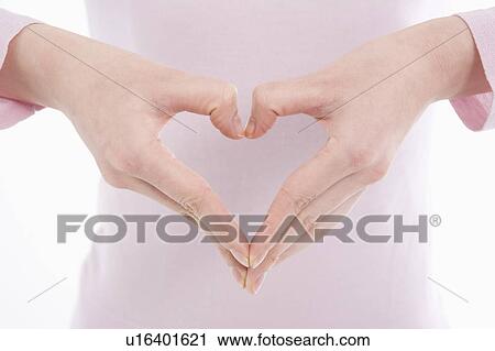Woman making heart shape with her hands View Large Photo Image Stock Image - Woman making heart shape with her hands. Fotosearch