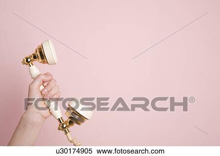 Woman's hand holding telephone receiver View Large Photo Image Stock Photography - Woman's hand holding telephone receiver. Fotosearch