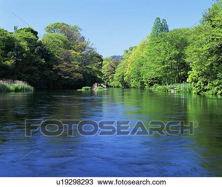 Stock Image - Clear water flowing in river. Fotosearch