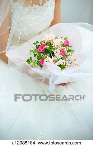 A bride holding a bouquet View Large Photo Image Picture - A bride holding a bouquet. Fotosearch