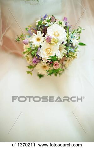 Stock Image - A bride holding a bouquet. Fotosearch