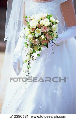 Stock Image - A bride holding a bouquet. Fotosearch