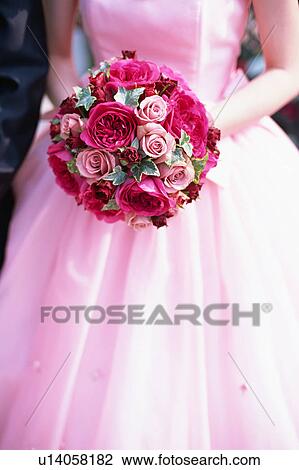 Stock Image - A bride holding a bouquet. Fotosearch