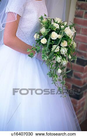 A bride holding a bouquet View Large Photo Image Stock Image - A bride holding a bouquet. Fotosearch