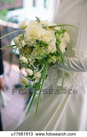 A bride holding a bouquet View Large Photo Image Stock Image - A bride holding a bouquet. Fotosearch