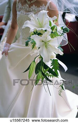 Stock Photography - A bride holding a bouquet. Fotosearch
