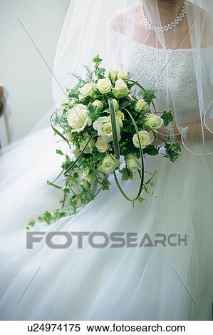 A bride holding a bouquet View Large Photo Image Stock Photography - A bride holding a bouquet. Fotosearch