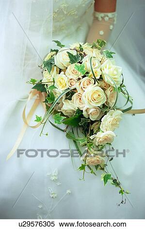 Stock Photography - A bride holding a bouquet. Fotosearch