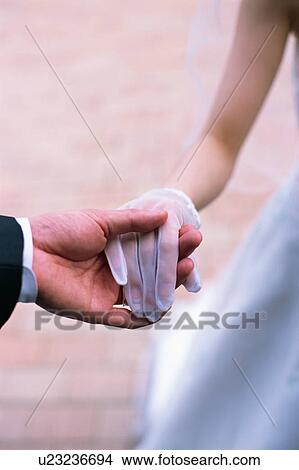 Groom holding a hand of a bride View Large Photo Image Picture - Groom holding a hand of a bride. Fotosearch