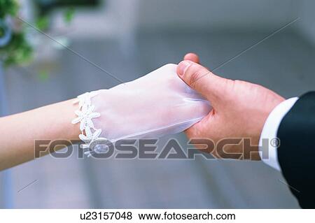 Groom holding a hand of a bride View Large Photo Image Stock Photo - Groom holding a hand of a bride. Fotosearch